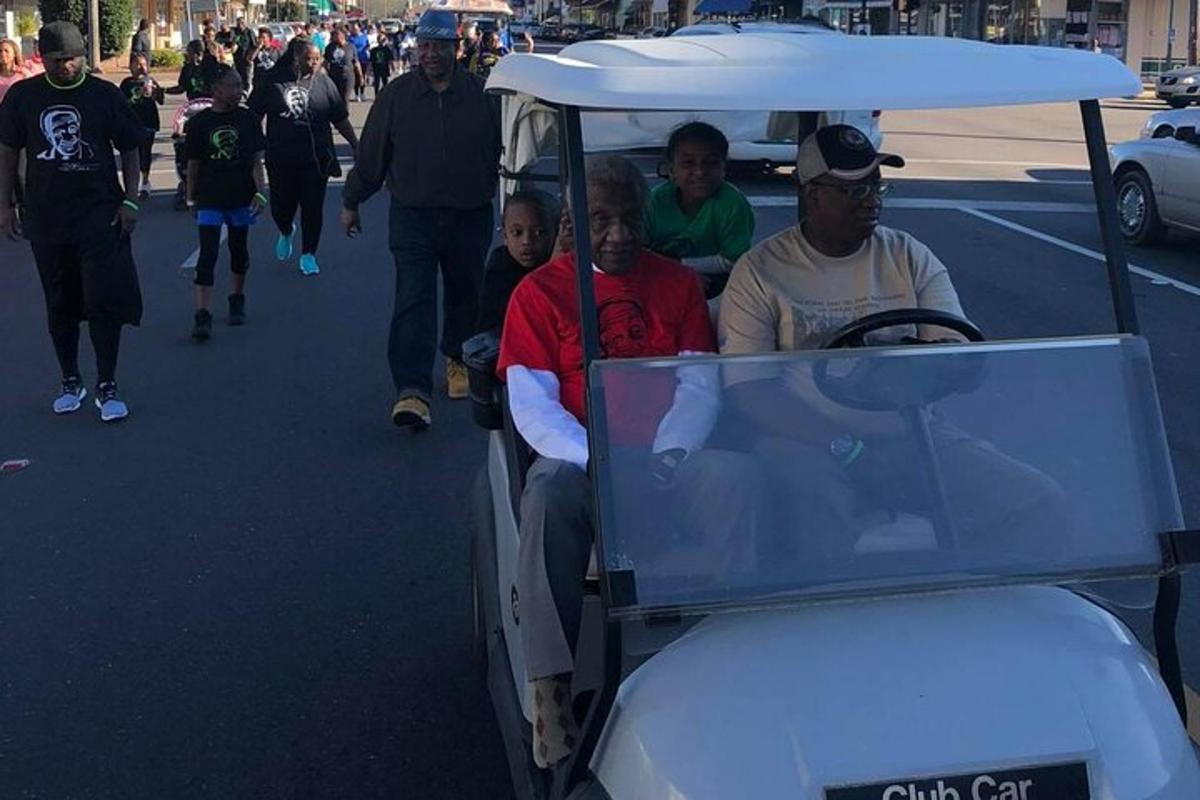 a group of people riding in a golf cart