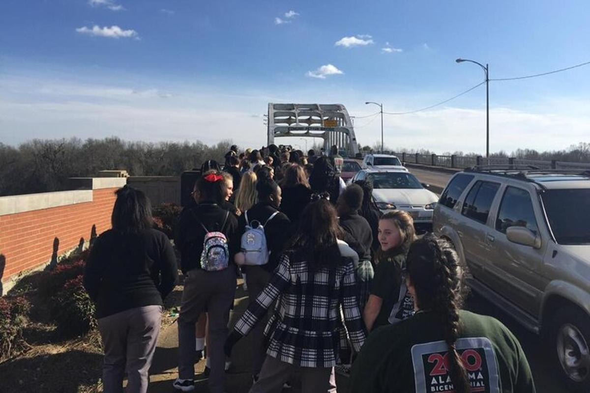 a group of people standing in a parking lot
