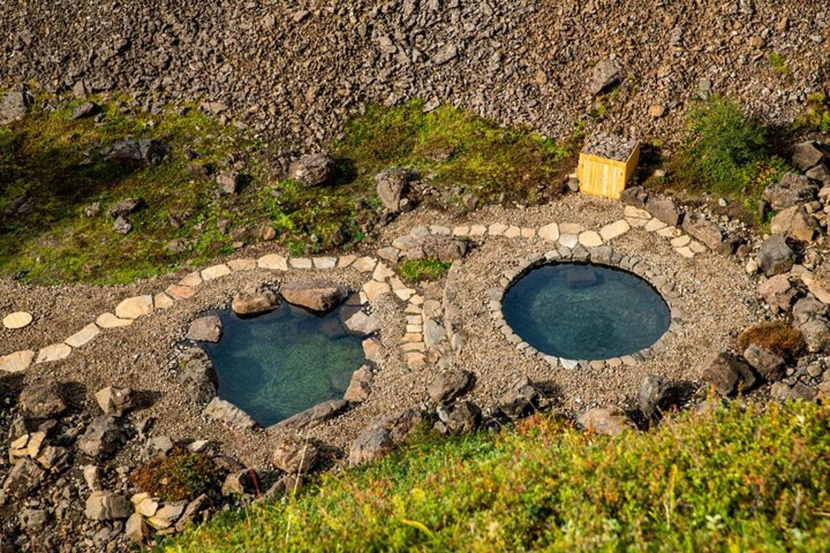 two small pools of water in a rock garden