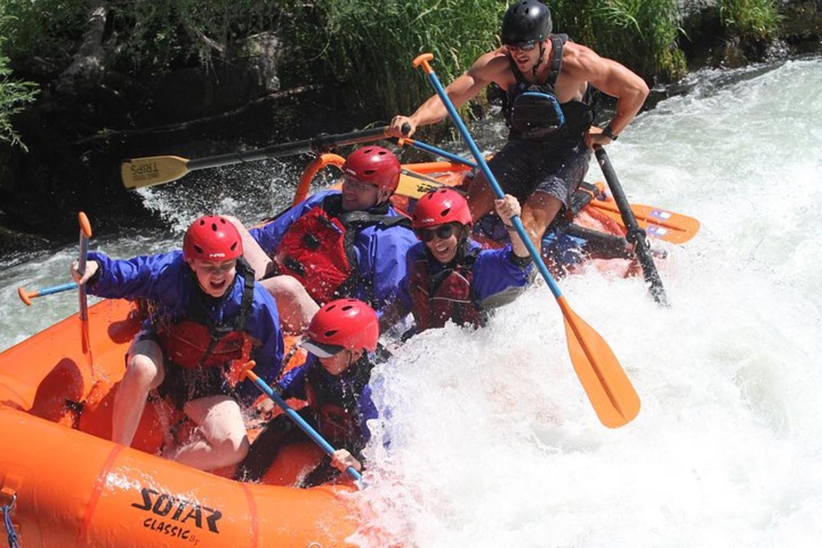 a group of people in a raft in the water