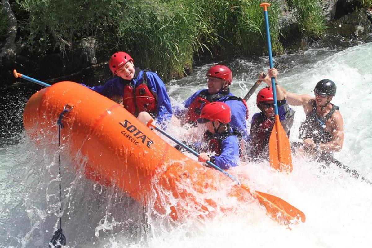 a group of people in a raft on a river
