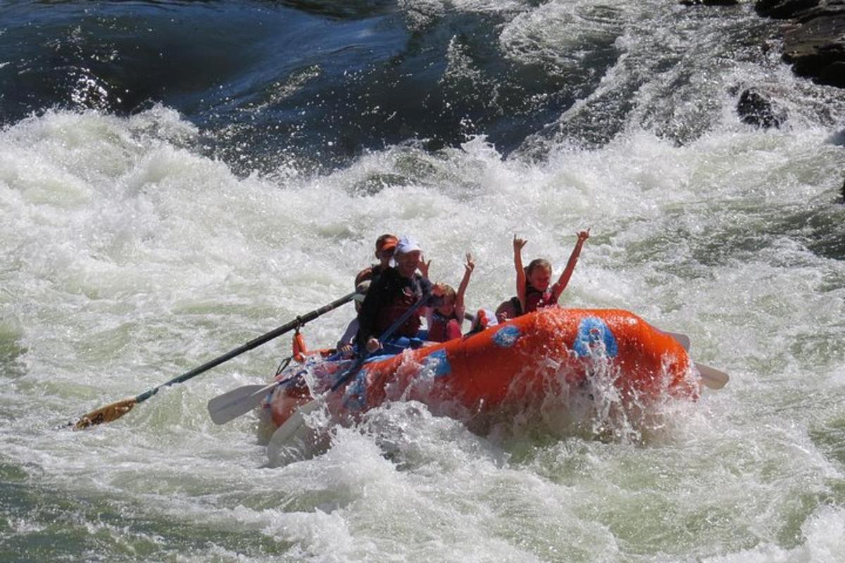 a group of people in a raft in a river