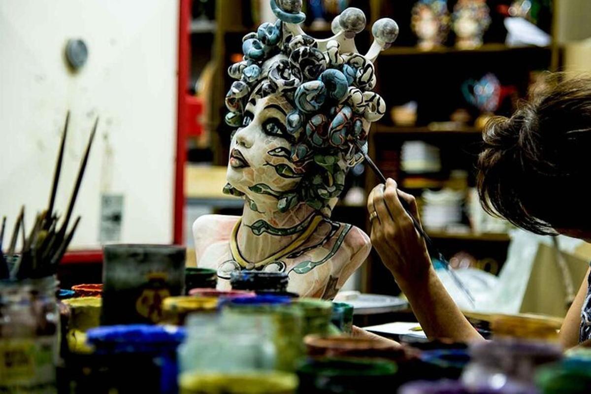 a woman painting a statue of a woman with her hair