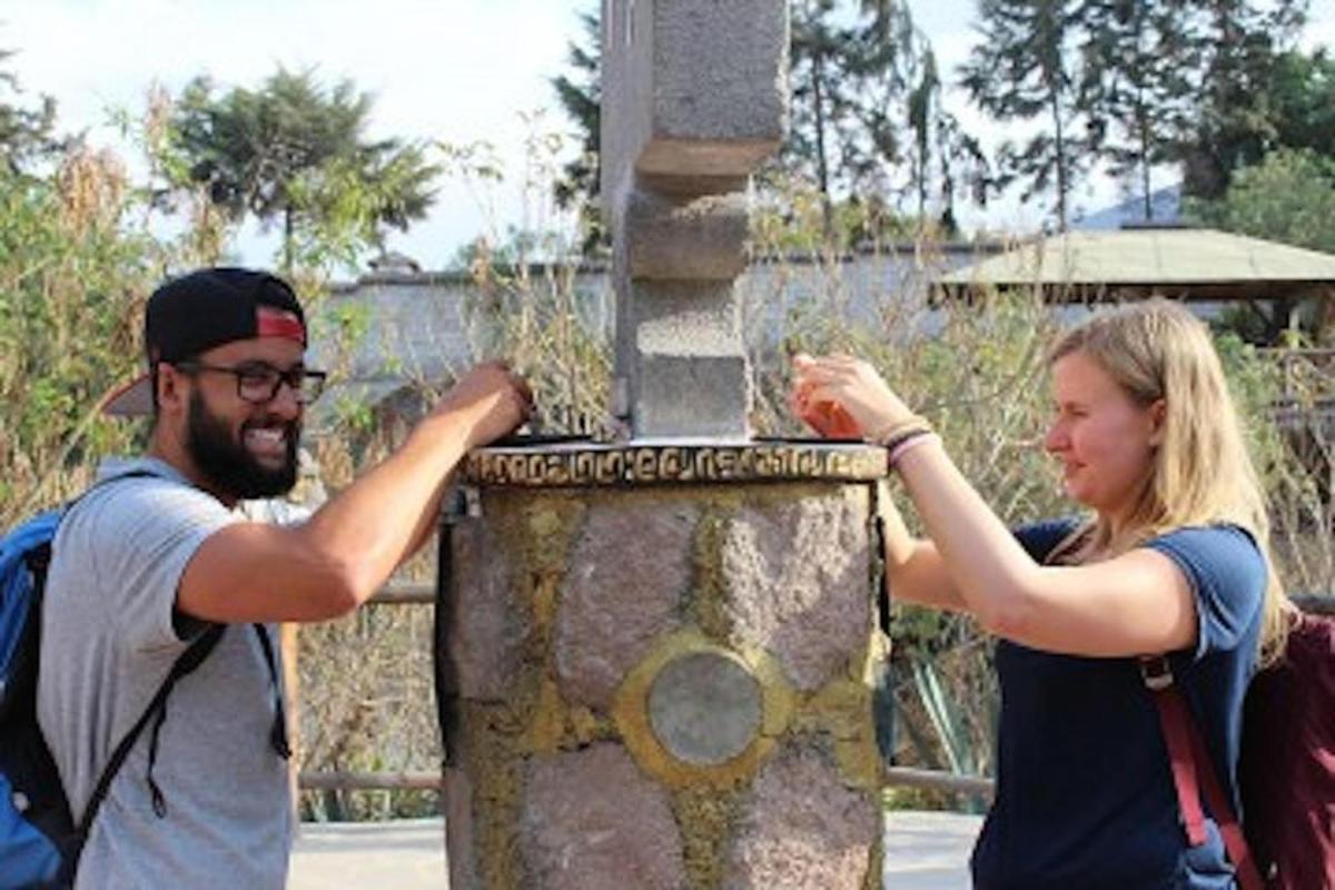 a man and a woman standing next to a pole