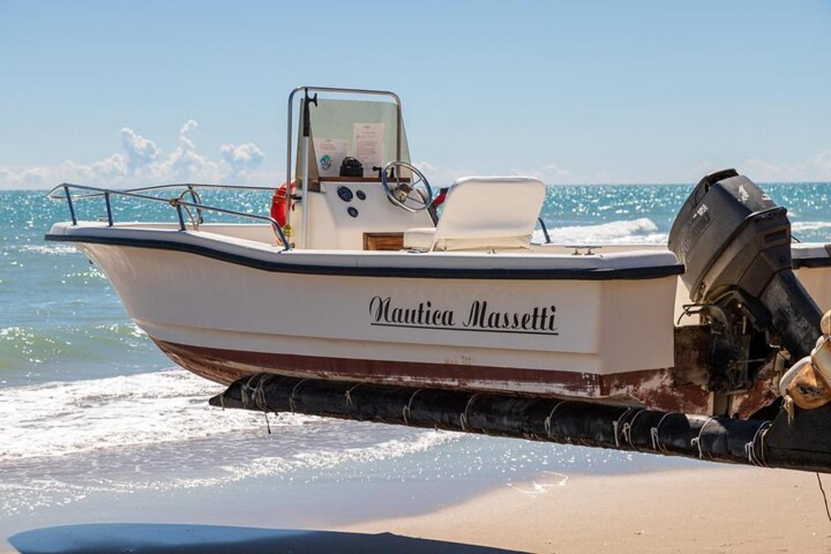 a boat sitting on the beach next to the ocean