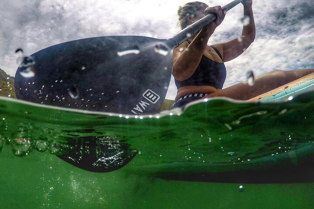 uma mulher sentada em uma prancha de surfe na água