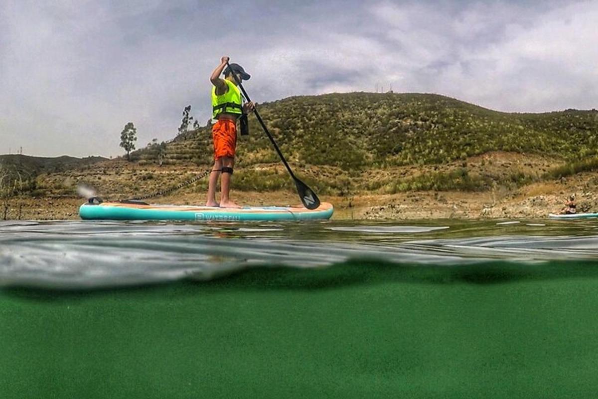 a man standing on a paddle board in the water