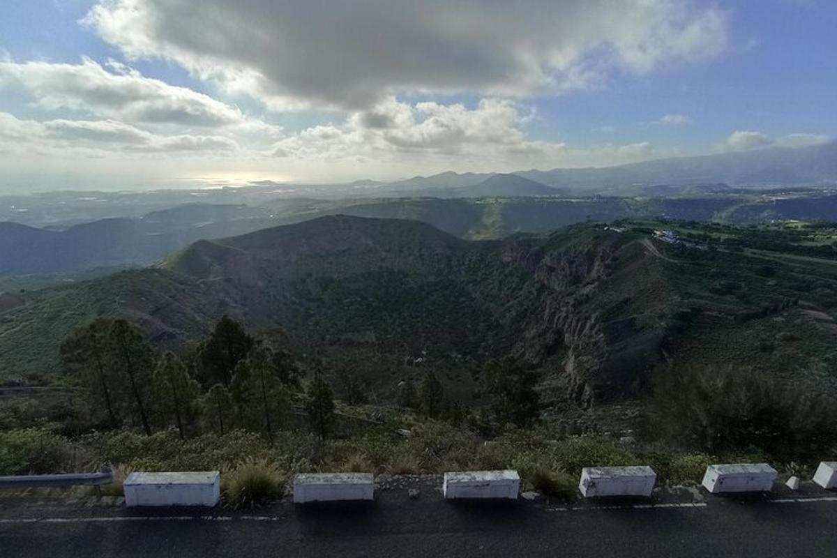 a view of a mountain with cars parked on a road