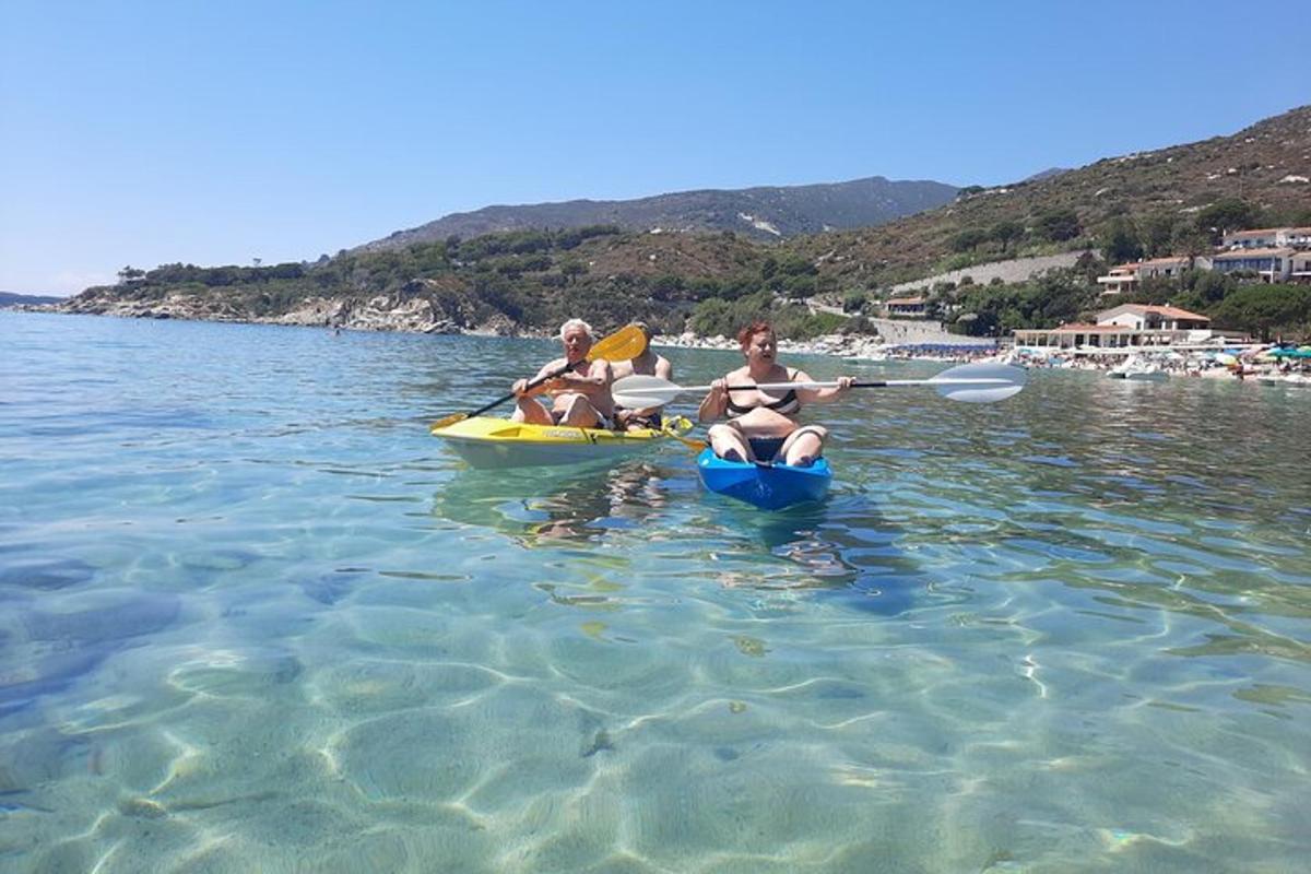a couple of people riding on kayaks in the water