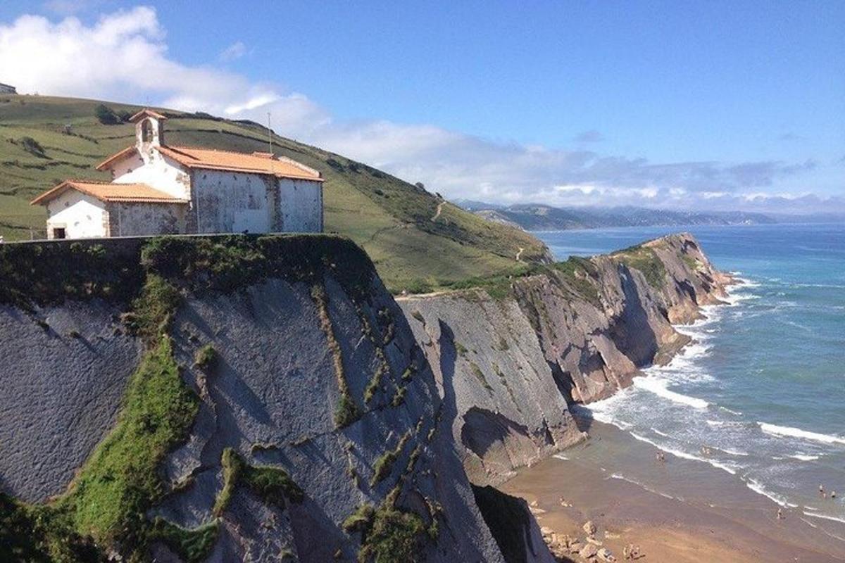 a building on top of a cliff next to the ocean
