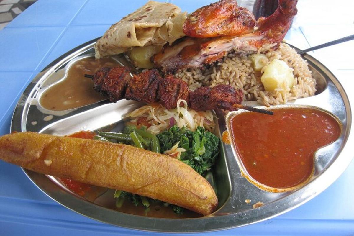 a plate of food with meat and rice and sauce