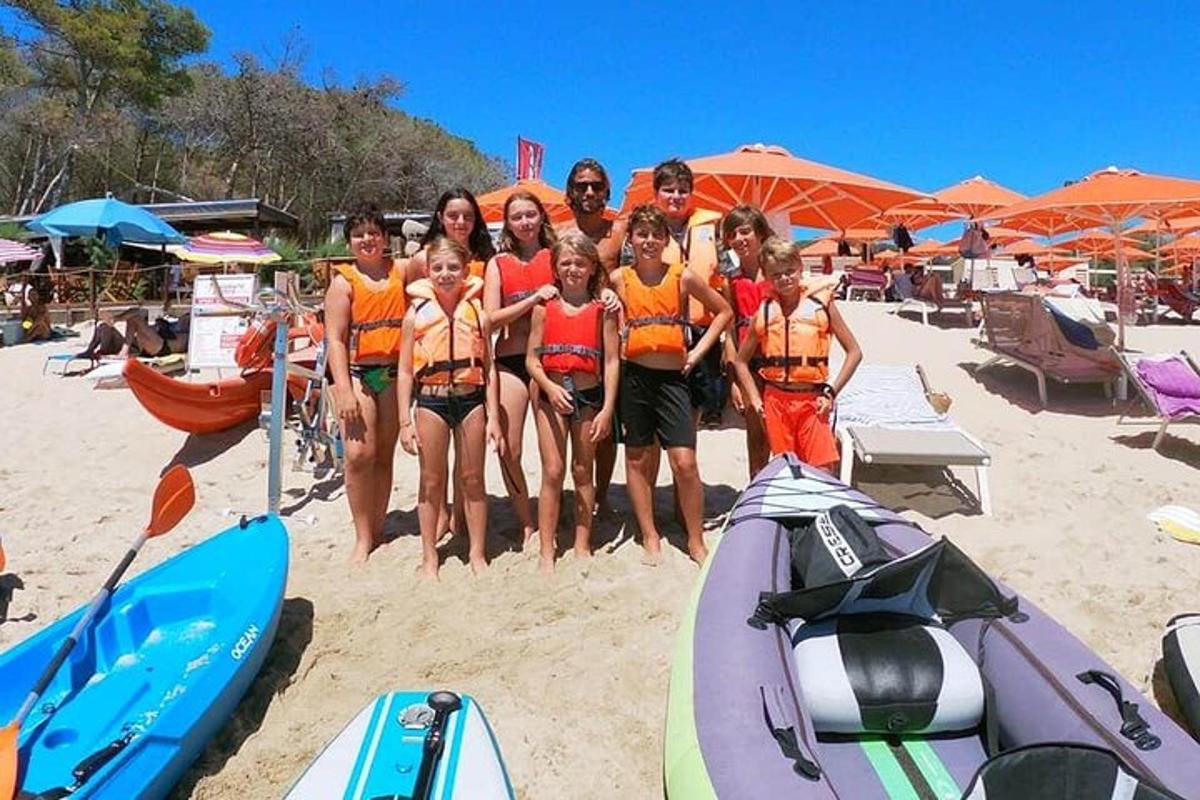 a group of women posing for a picture on the beach