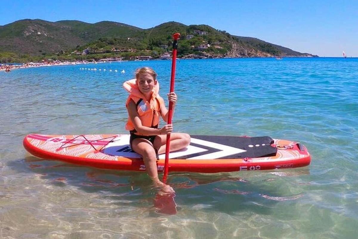 žena sedící na paddleboardu ve vodě