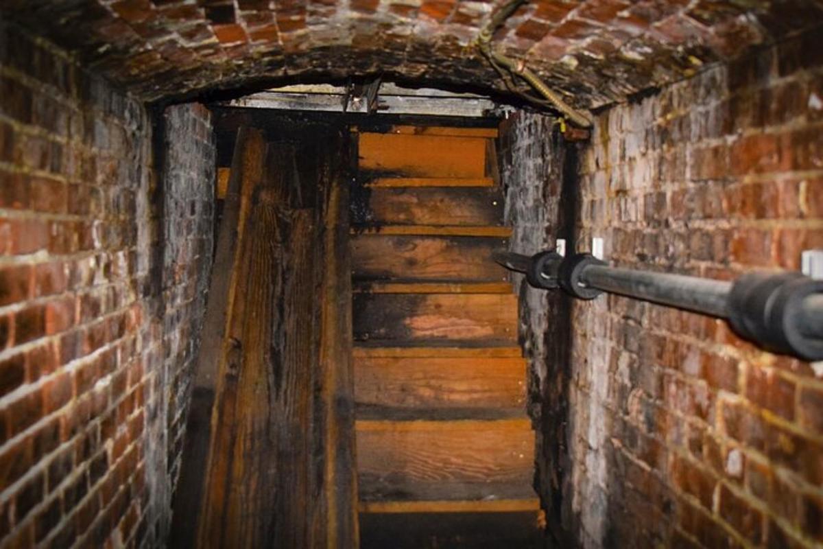 a brick tunnel with a door in a brick wall