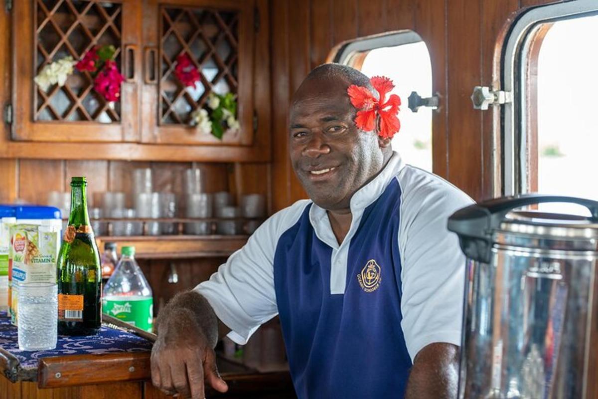 a man in a kitchen with a red bow on his head