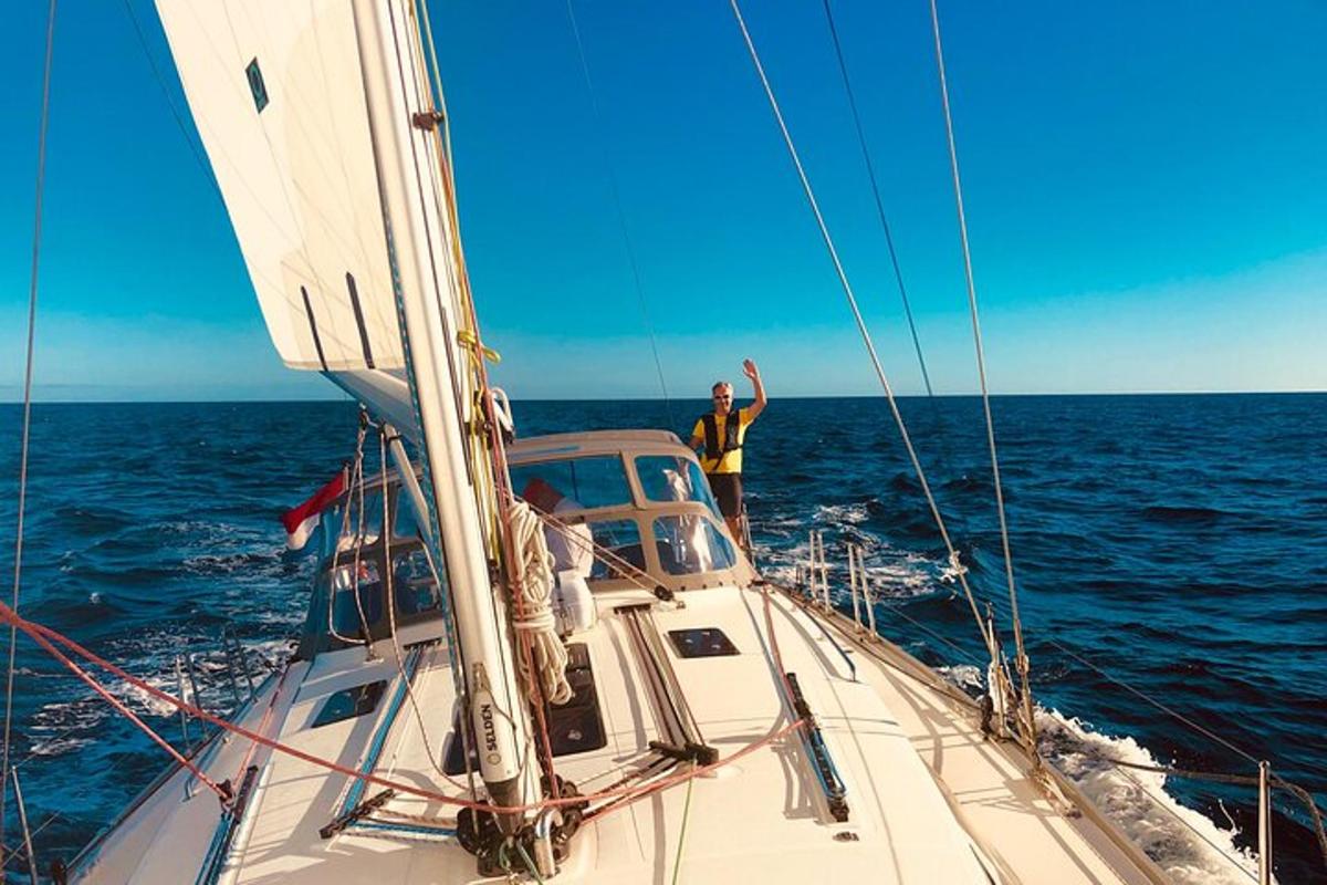two men on a sail boat in the ocean
