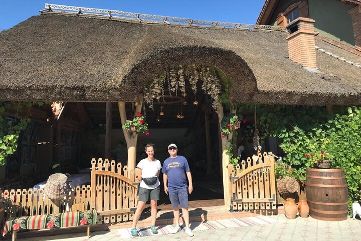 a man and a woman standing in front of a building