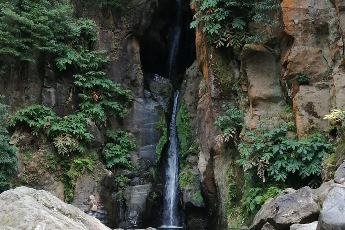 a waterfall on the side of a rock wall