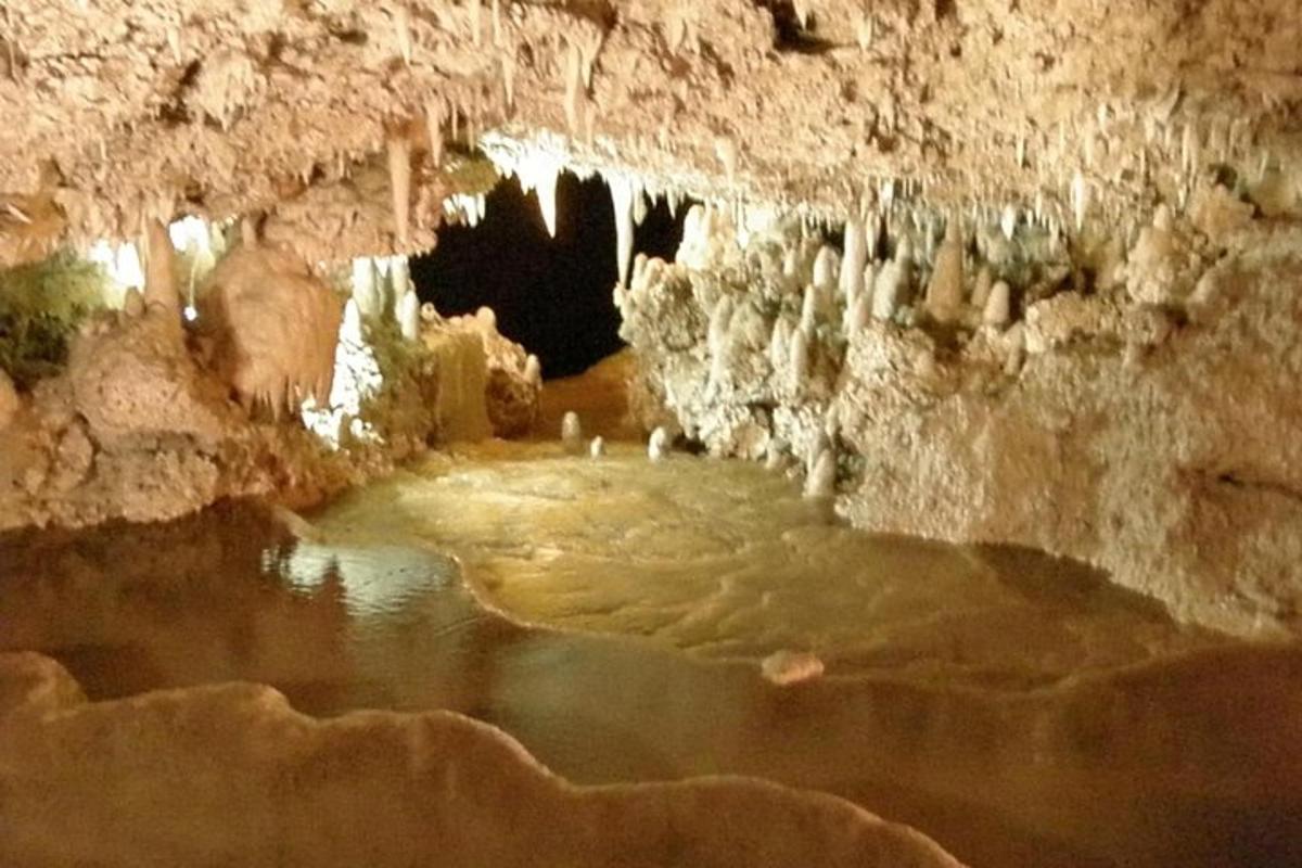 a cave with a pool of water inside of it