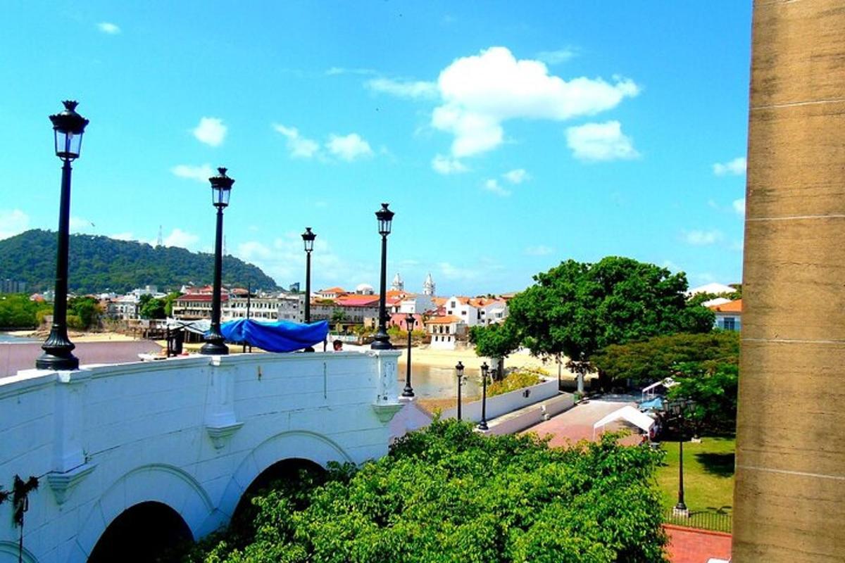 a view of a city street with a white building
