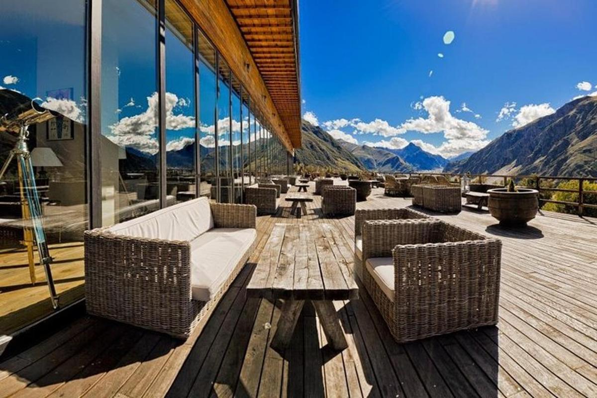 a patio with wicker chairs and tables on a building