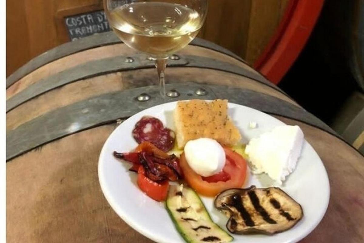 a plate of food on a table with a glass of wine