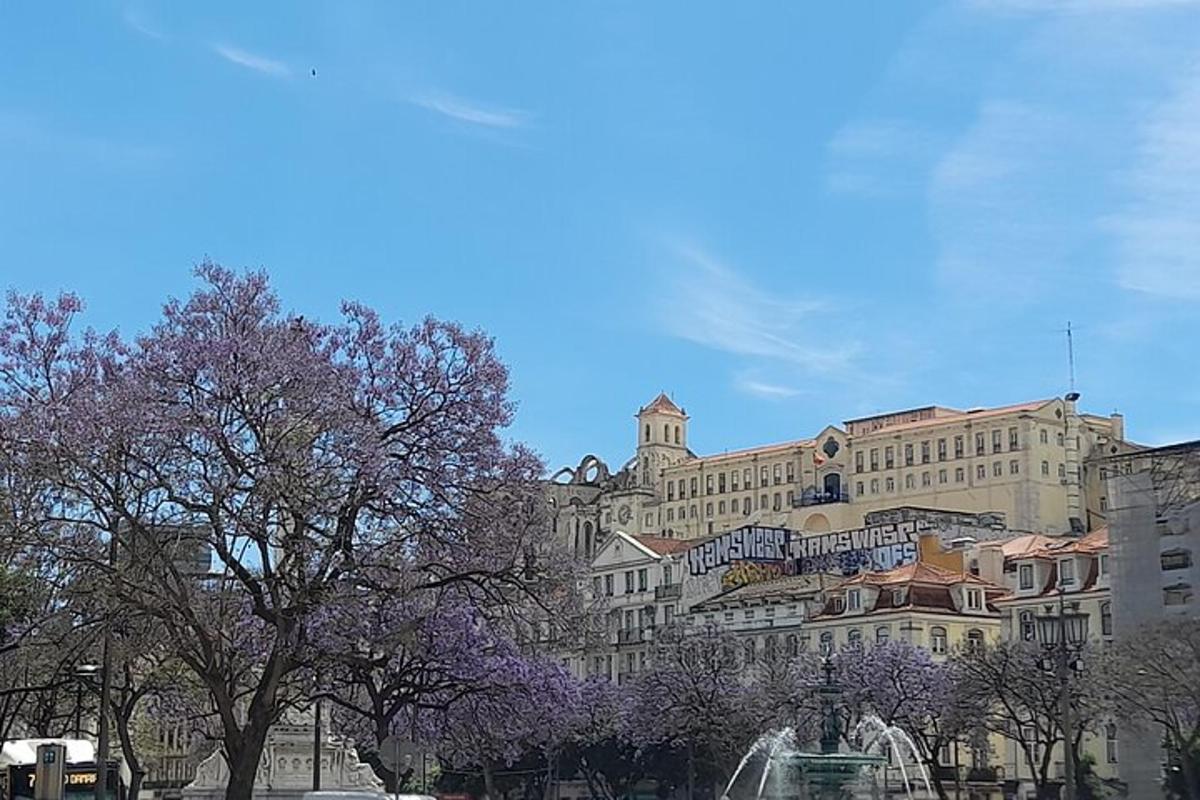 a large building with purple trees in front of it