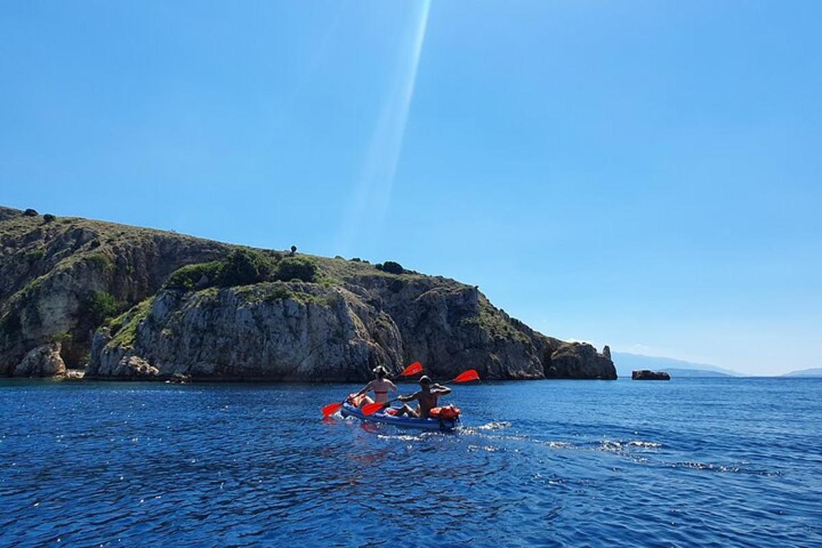 two people are in a kayak in the water