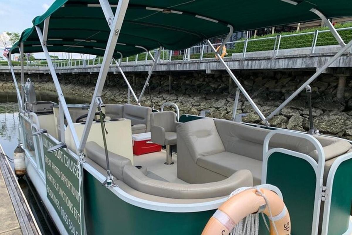 a boat with chairs and an umbrella on the water