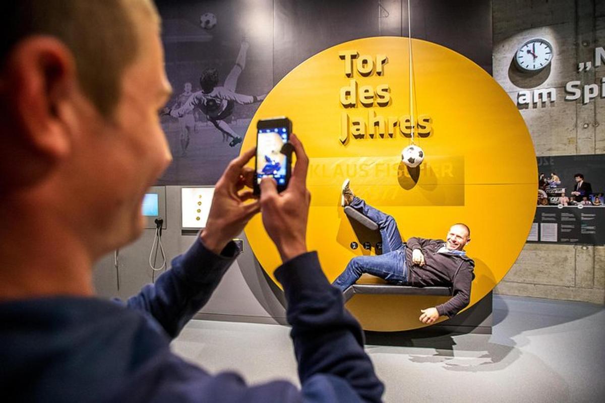 a man taking a picture of a man on a clock