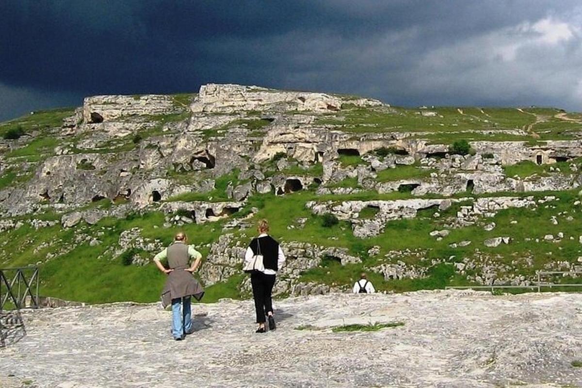 two people walking on top of a mountain