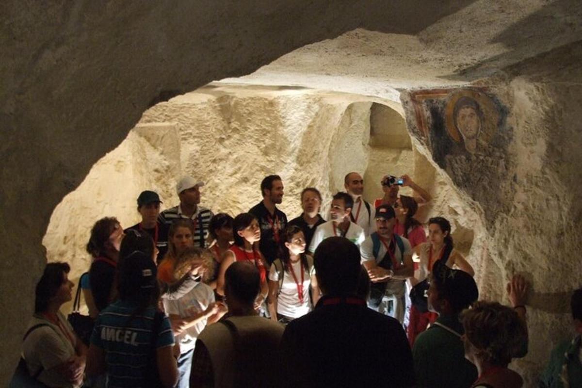 a group of people posing for a picture in a cave