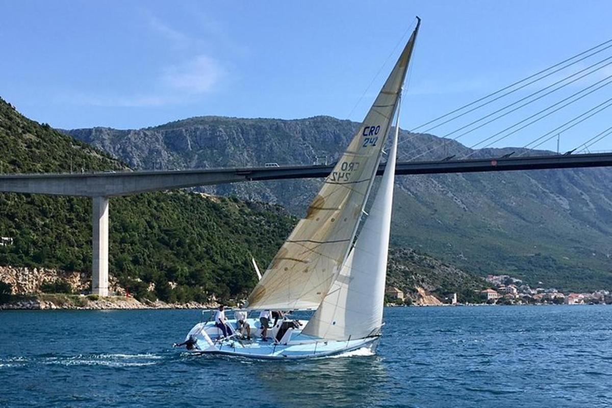 un velero en el agua debajo de un puente