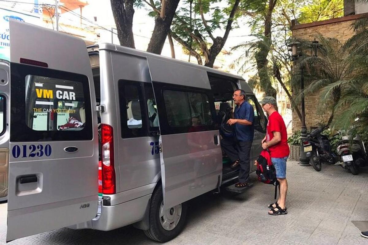 two men standing in the back of a van