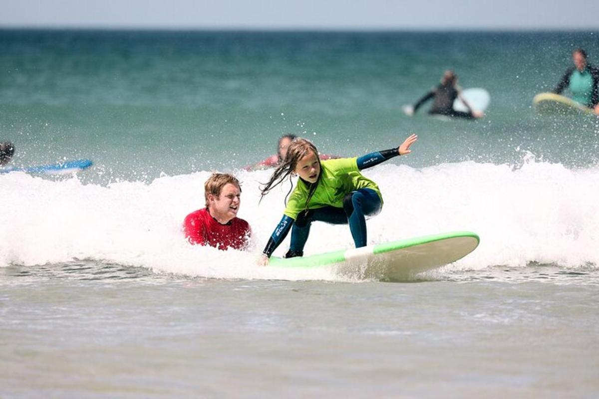 a young girl riding a wave on a surfboard in the ocean