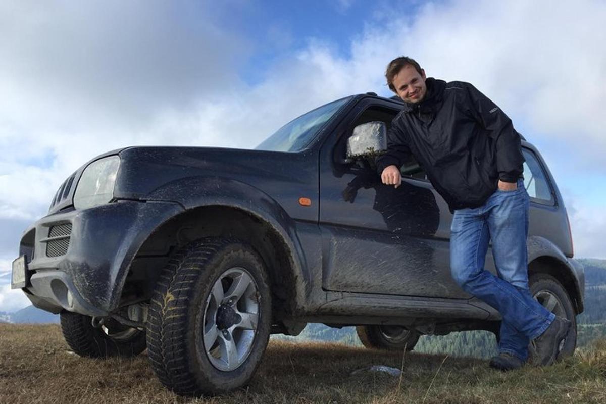 a man leaning on the back of a black truck