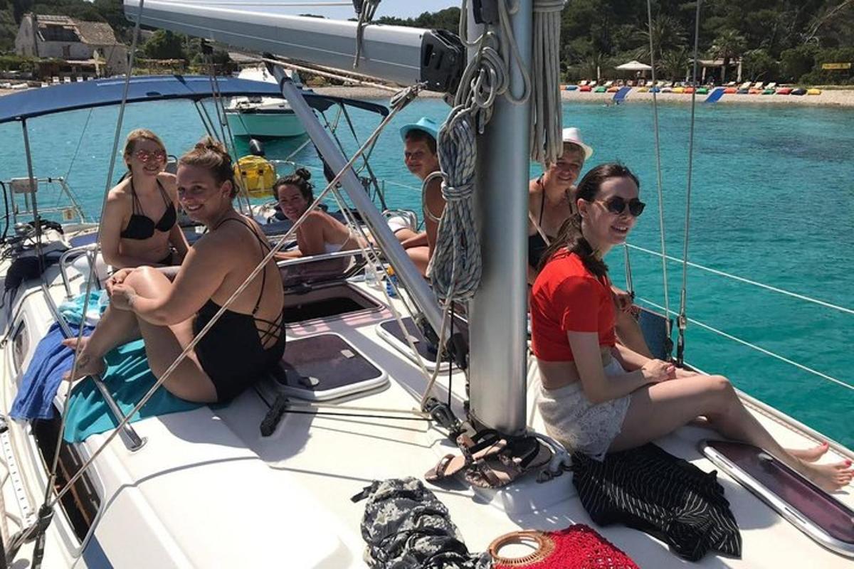 a group of people sitting on a boat in the water
