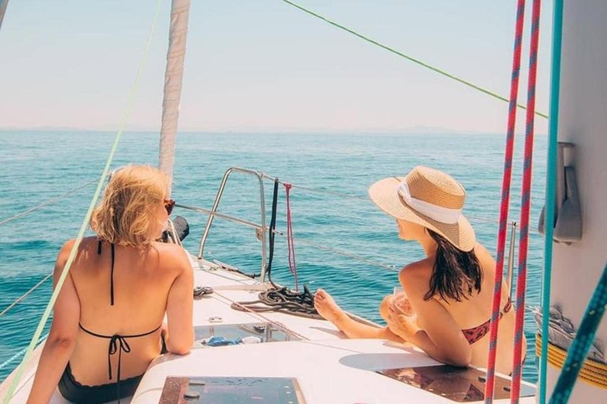 two women sitting on a boat in the water