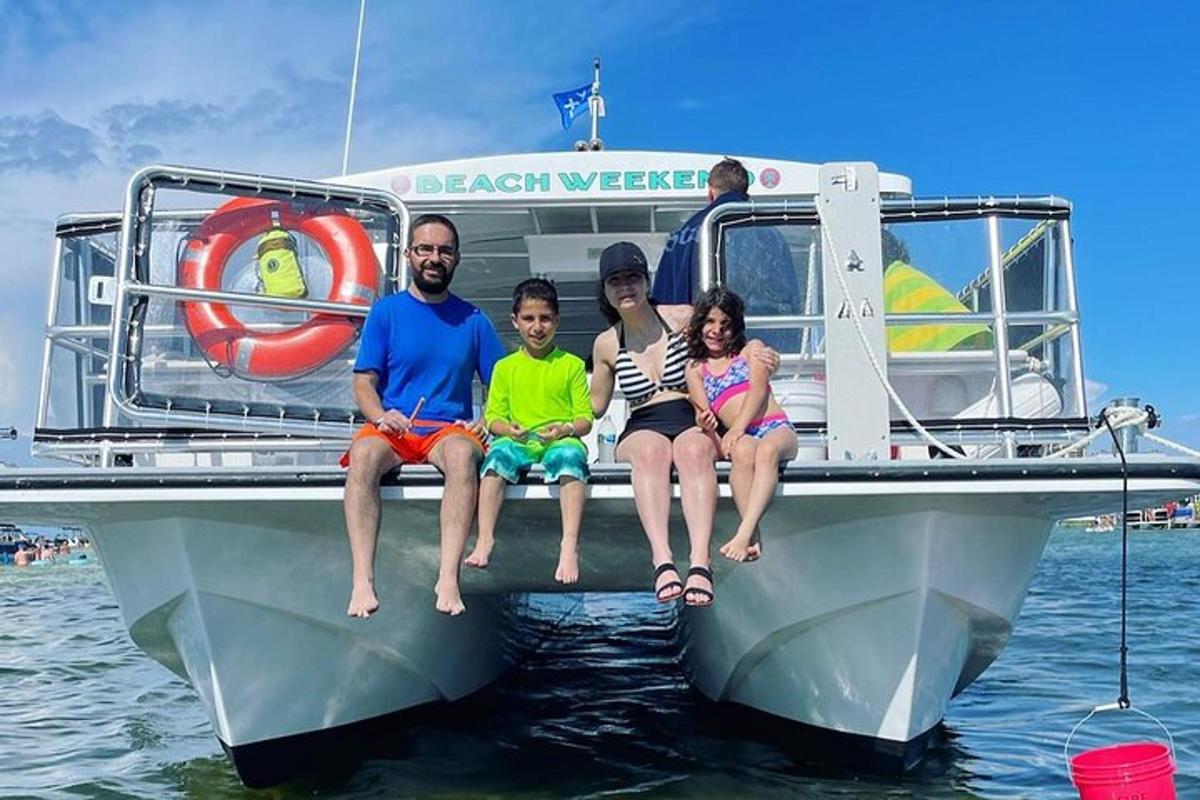 a group of people sitting on the back of a boat