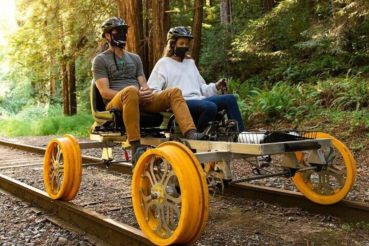 two men are sitting in a train car on the tracks