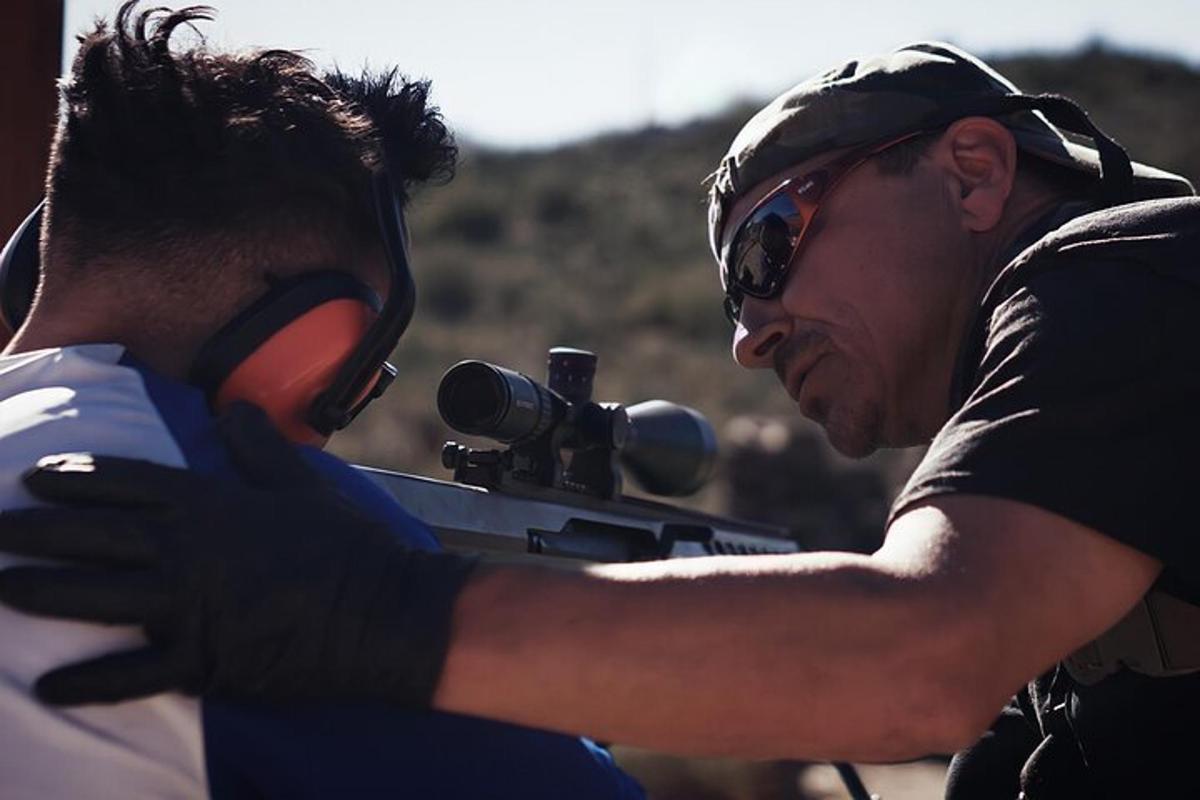 a man holding a gun next to another man
