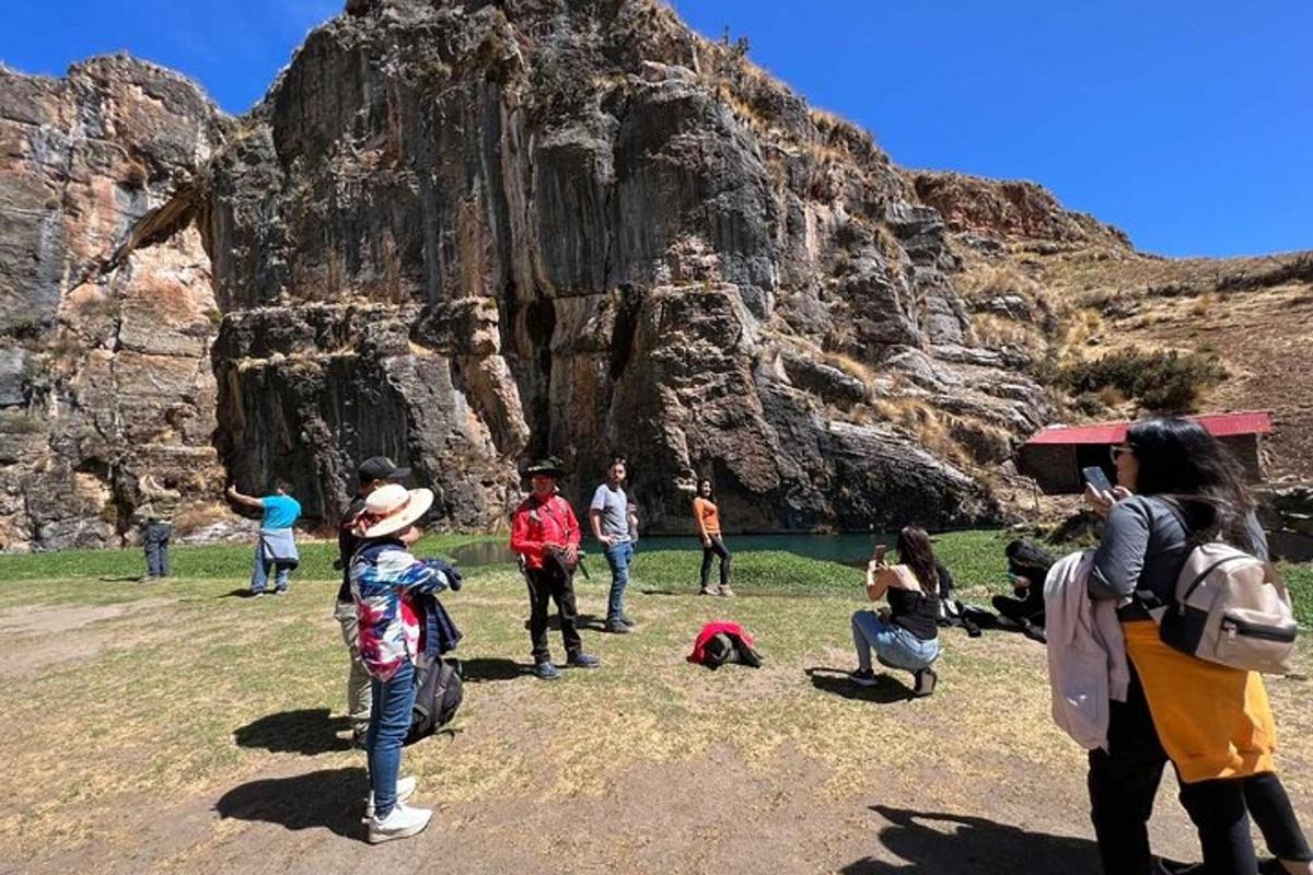 a group of people standing in front of a mountain