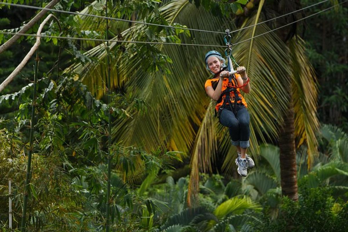 a woman swinging on a zip line in the jungle