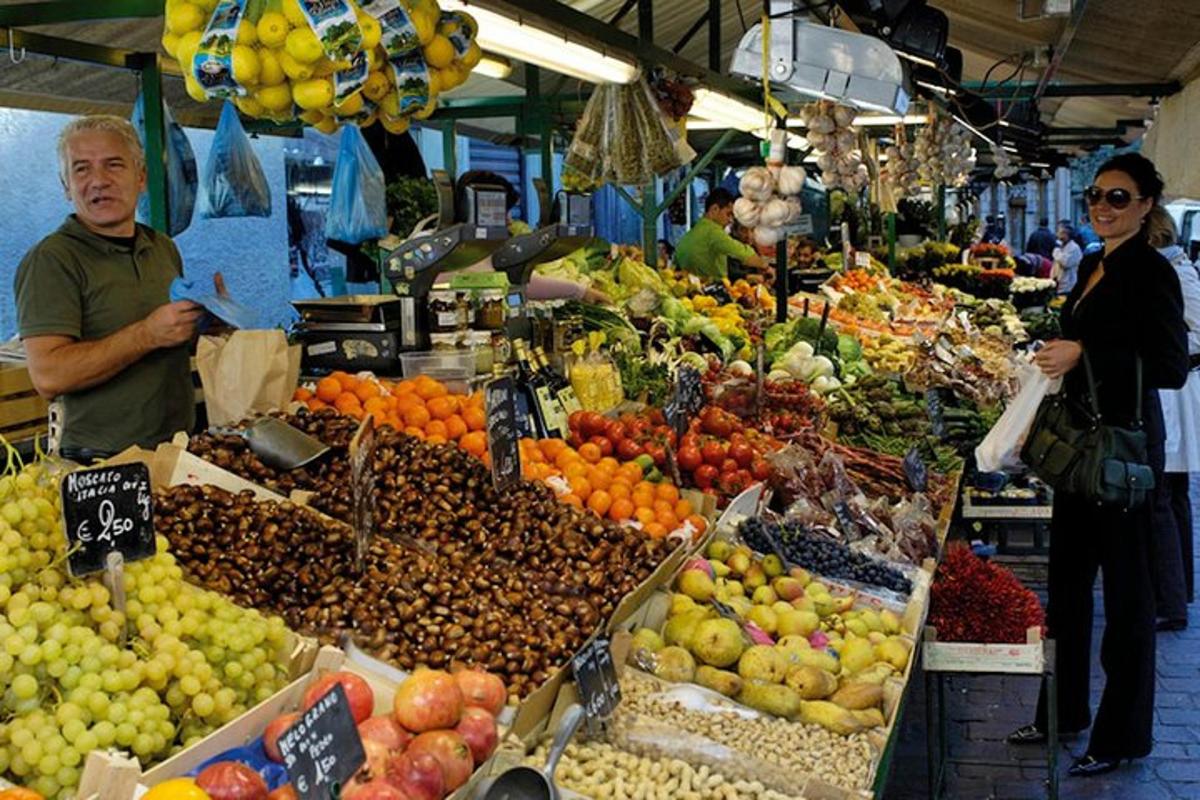 a man and woman standing in a market with fruits and vegetables