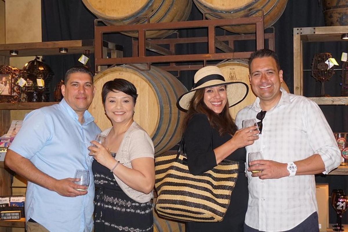 a group of people posing for a picture in a wine cellar