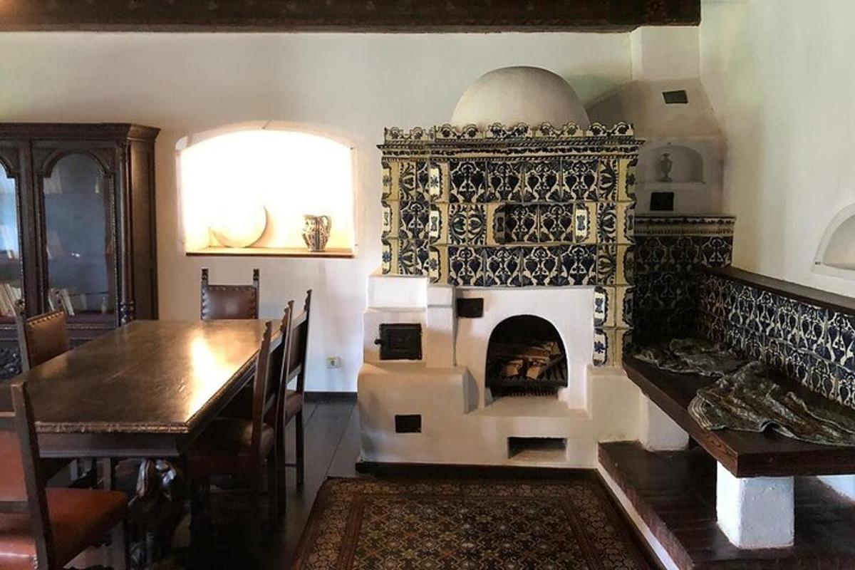 a room with a fireplace with a table and a dining room