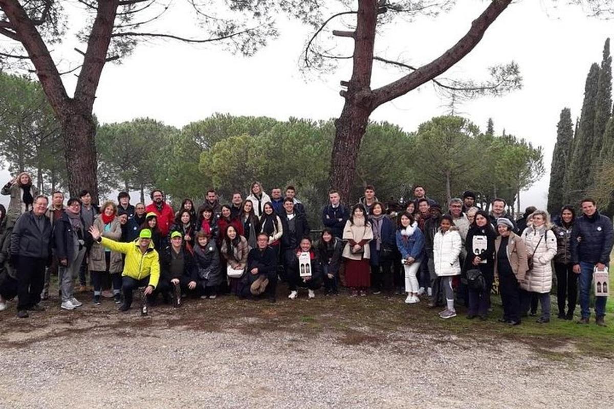 a group of people posing for a picture next to trees