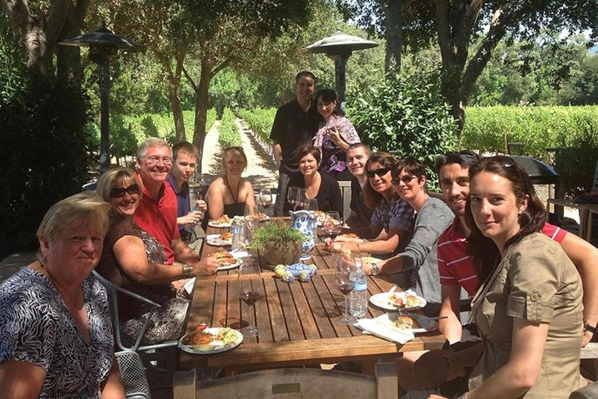 a group of people sitting around a wooden table