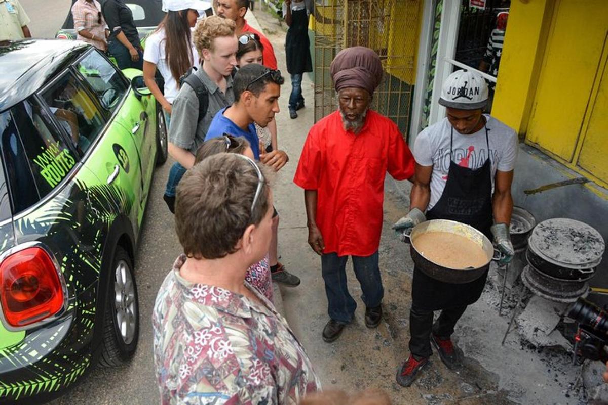 a group of people standing around a man playing a drum