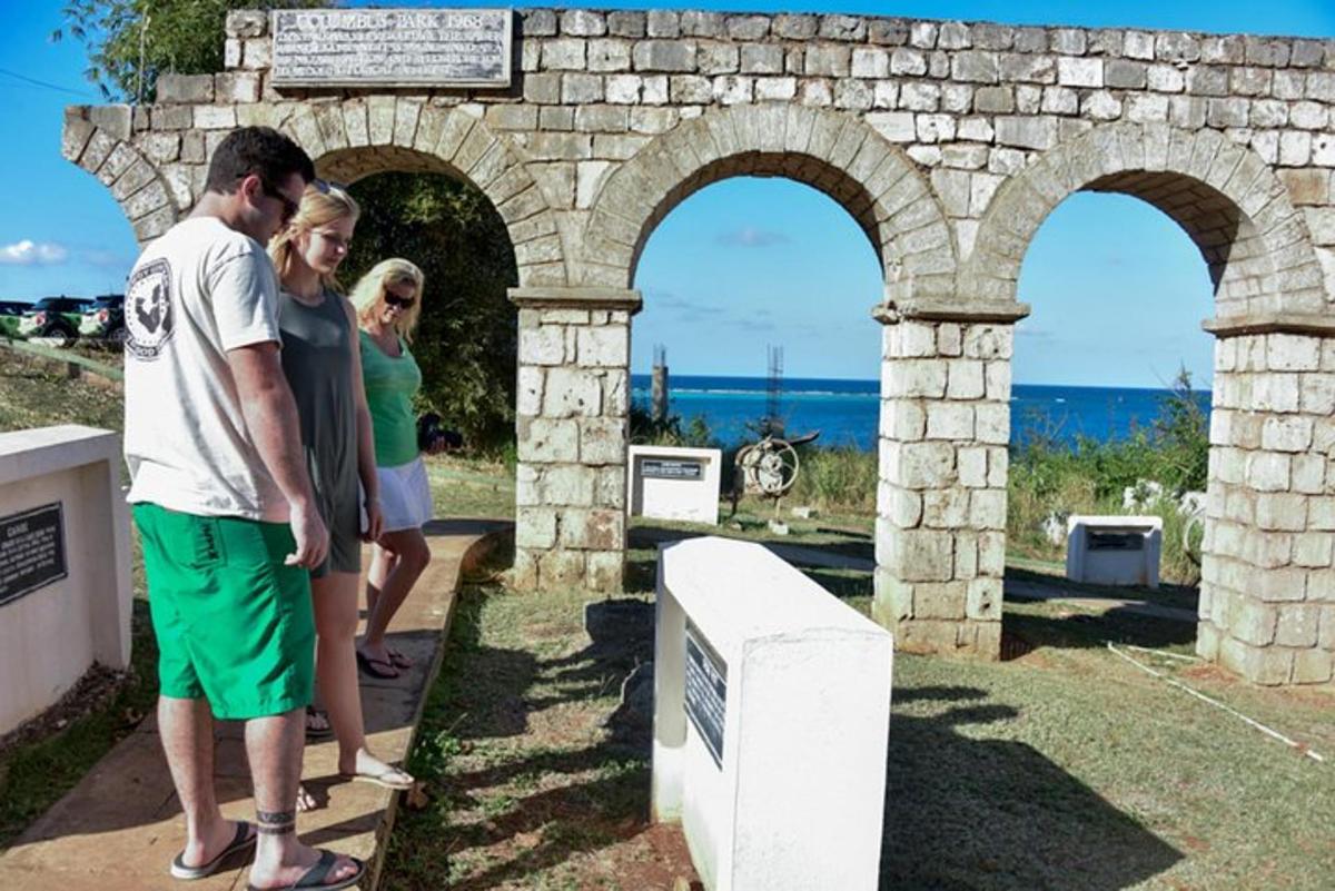 a group of people standing next to a stone wall